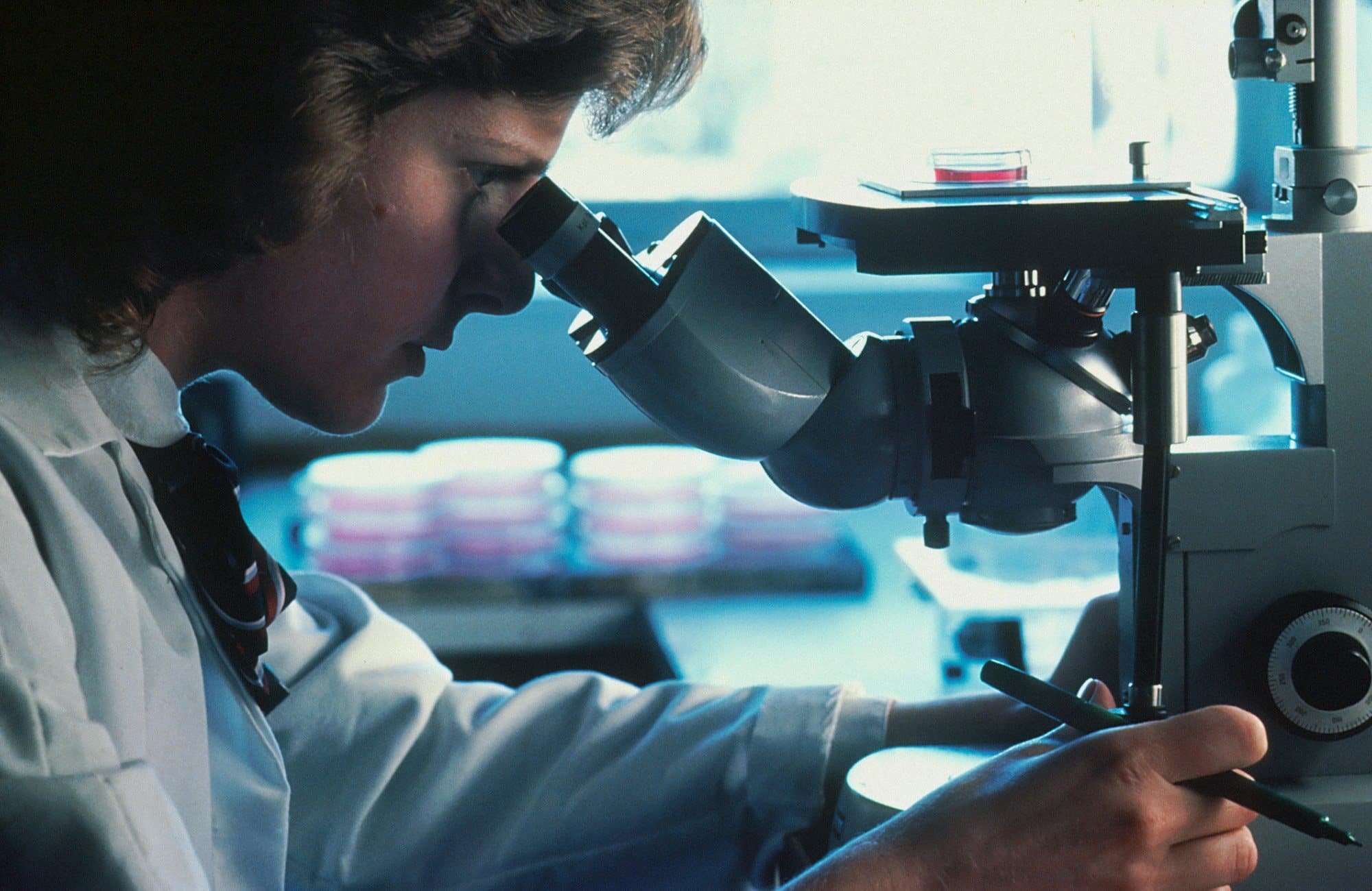 A researcher at a microscope