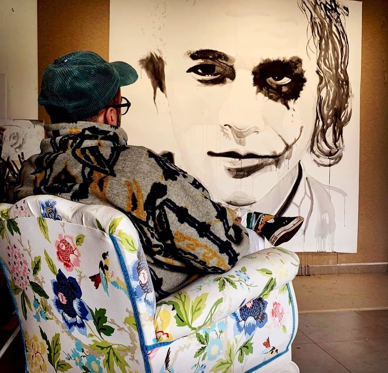 In the studio with an ink portrait of the Joker