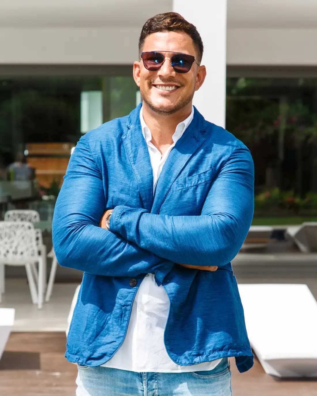 Maximillian White in a blue blazer, arms crossed